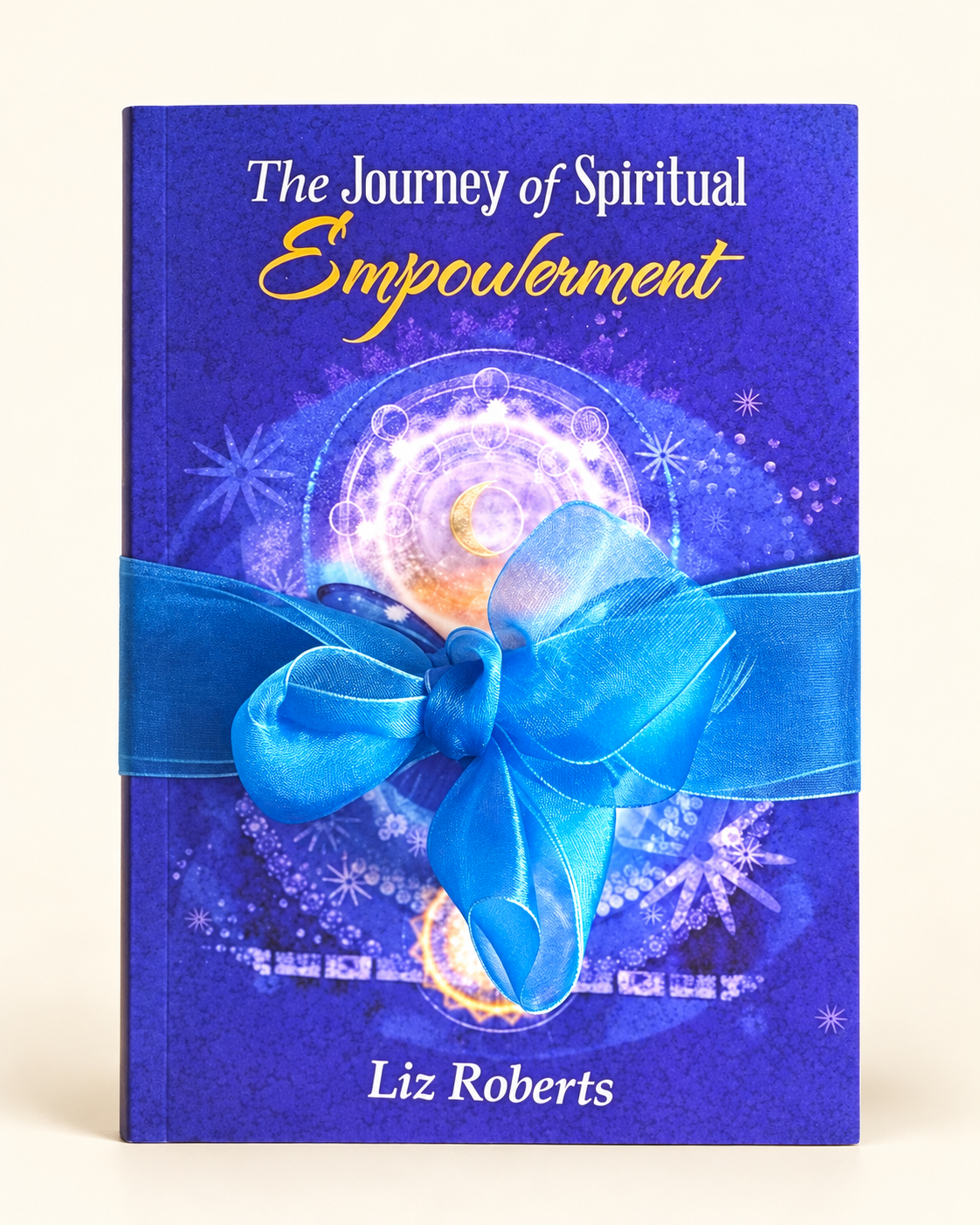 The Journey of Spiritual Empowerment by Liz Roberts, with its blue ribbon, on a cream background.